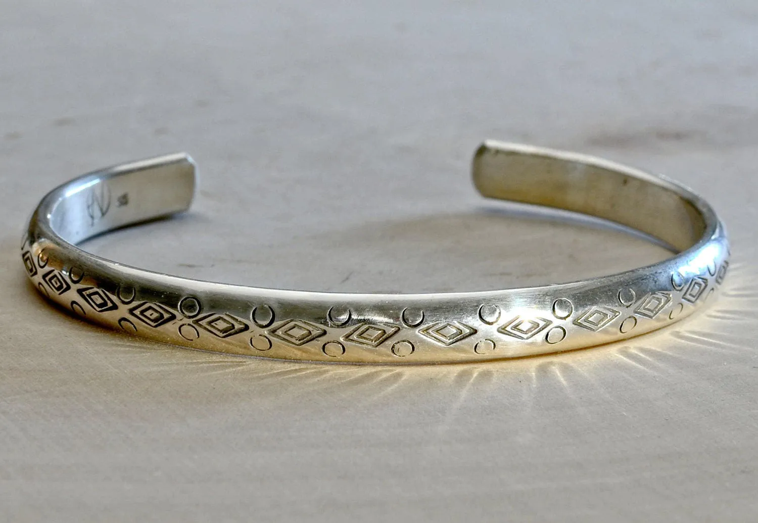 Half Round Cuff Bracelet in Sterling Silver imprinted using Handmade Native American Metal Stamps