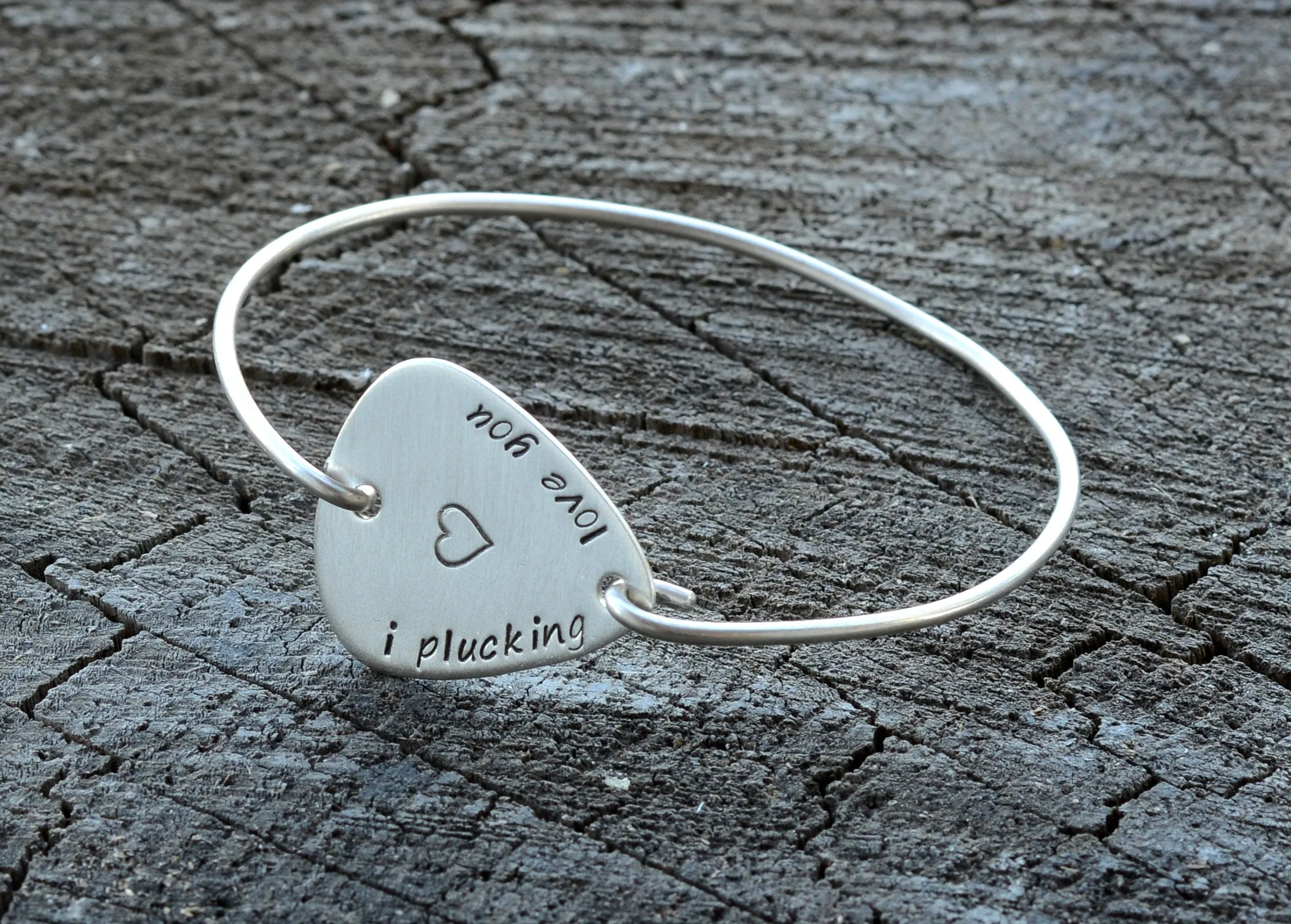 I plucking love you guitar pick set in a sterling silver tension bangle
