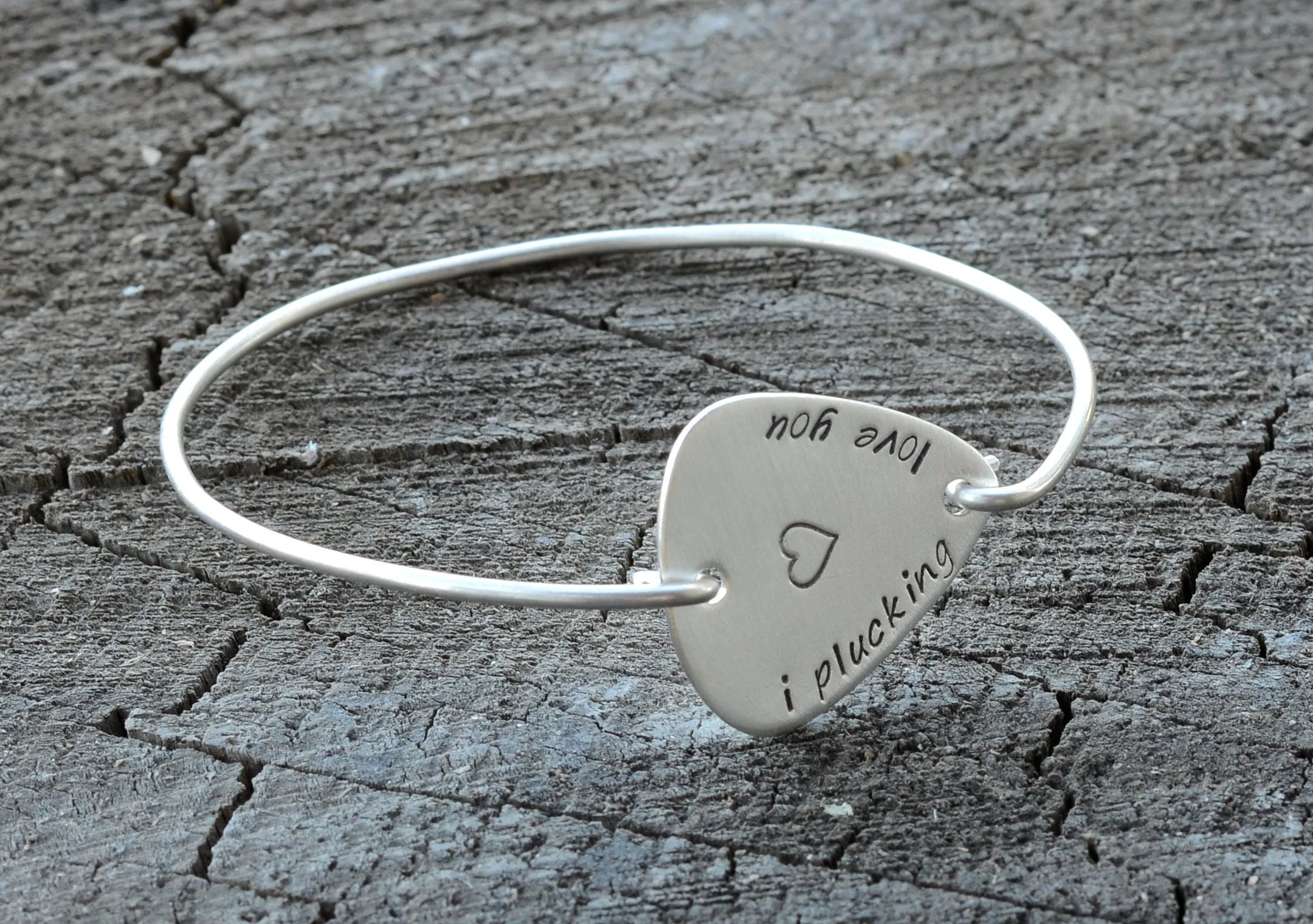 I plucking love you guitar pick set in a sterling silver tension bangle