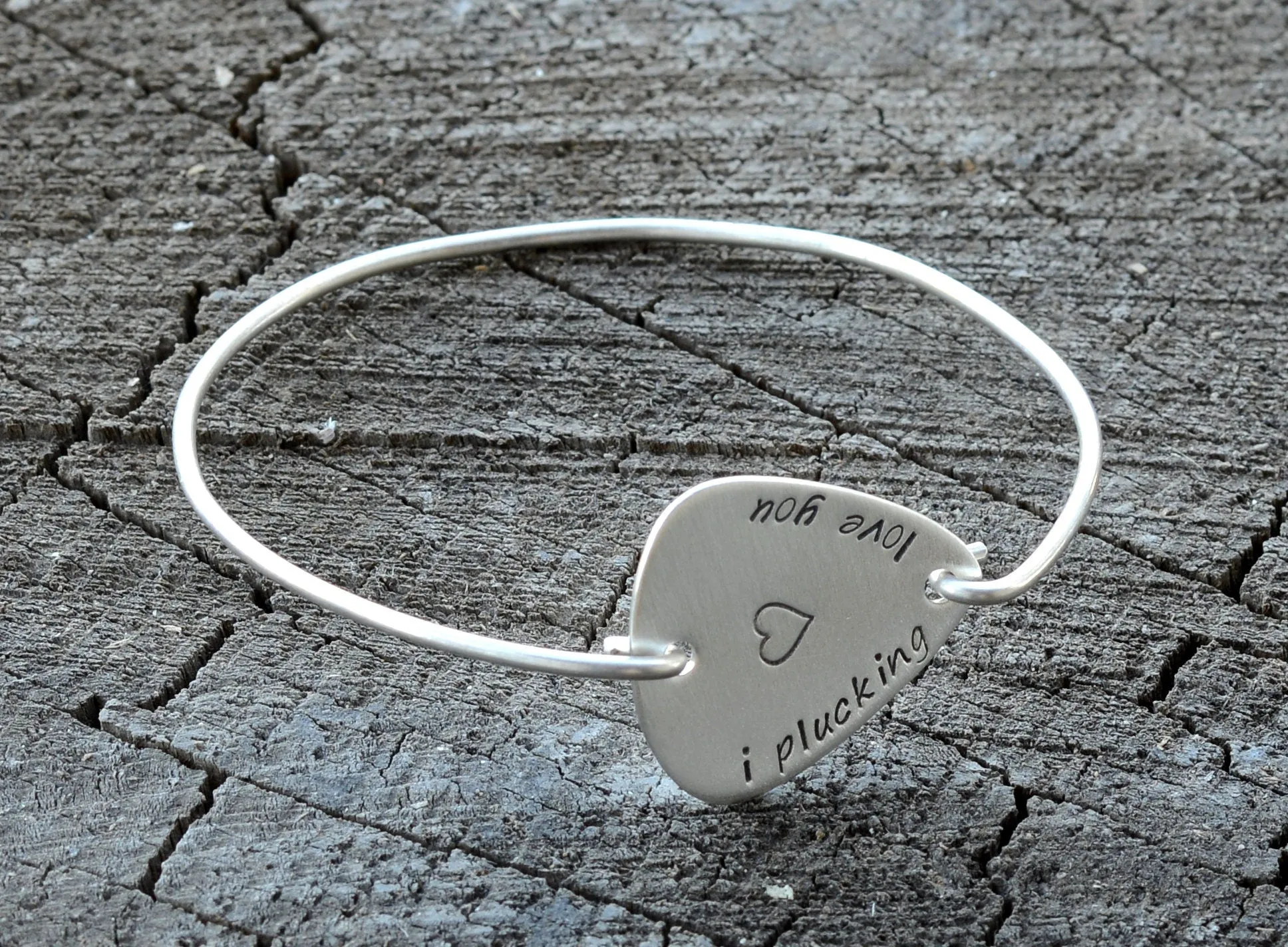 I plucking love you guitar pick set in a sterling silver tension bangle