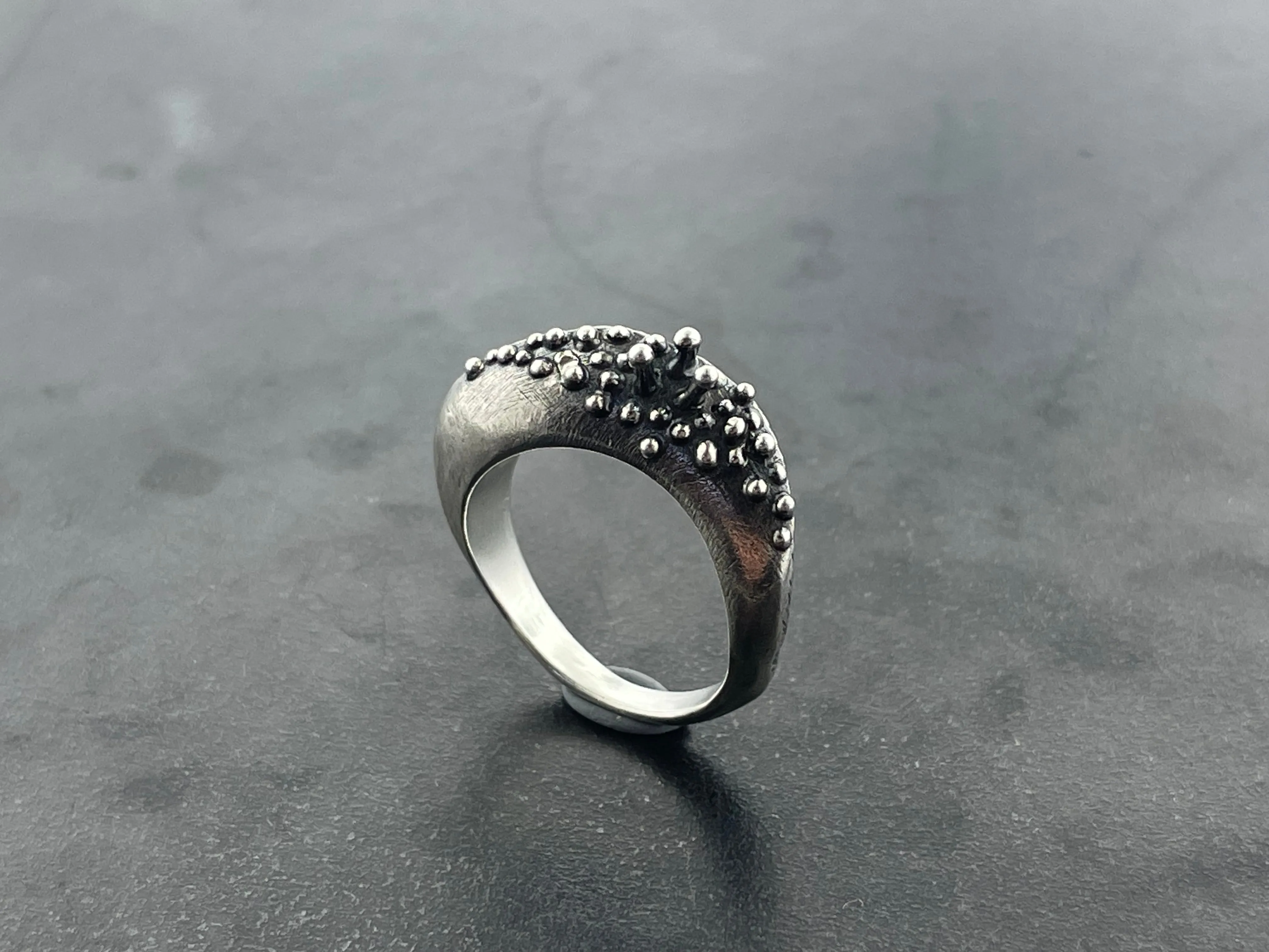 In Flow ring with knobbly  and scratch textures