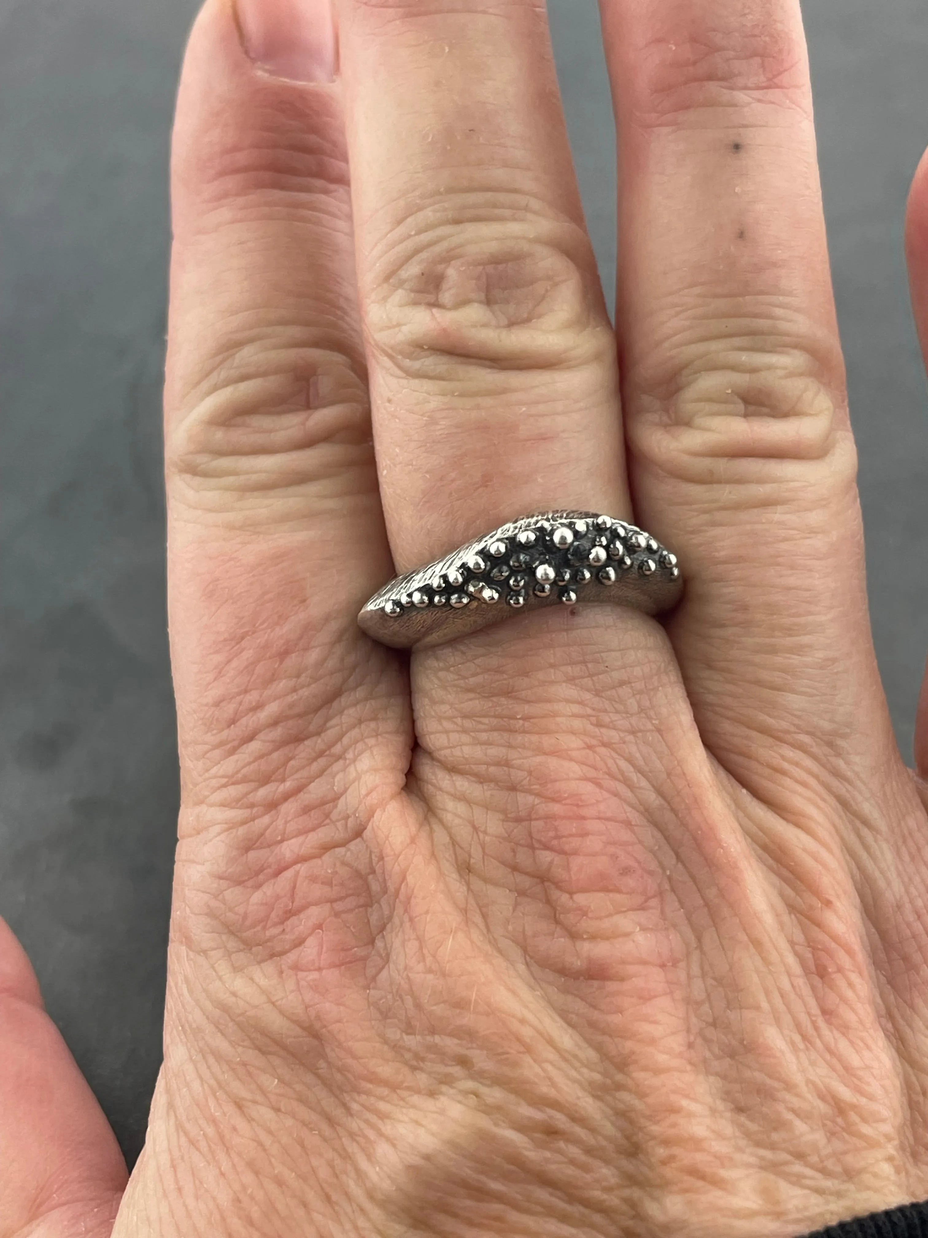 In Flow ring with knobbly  and scratch textures