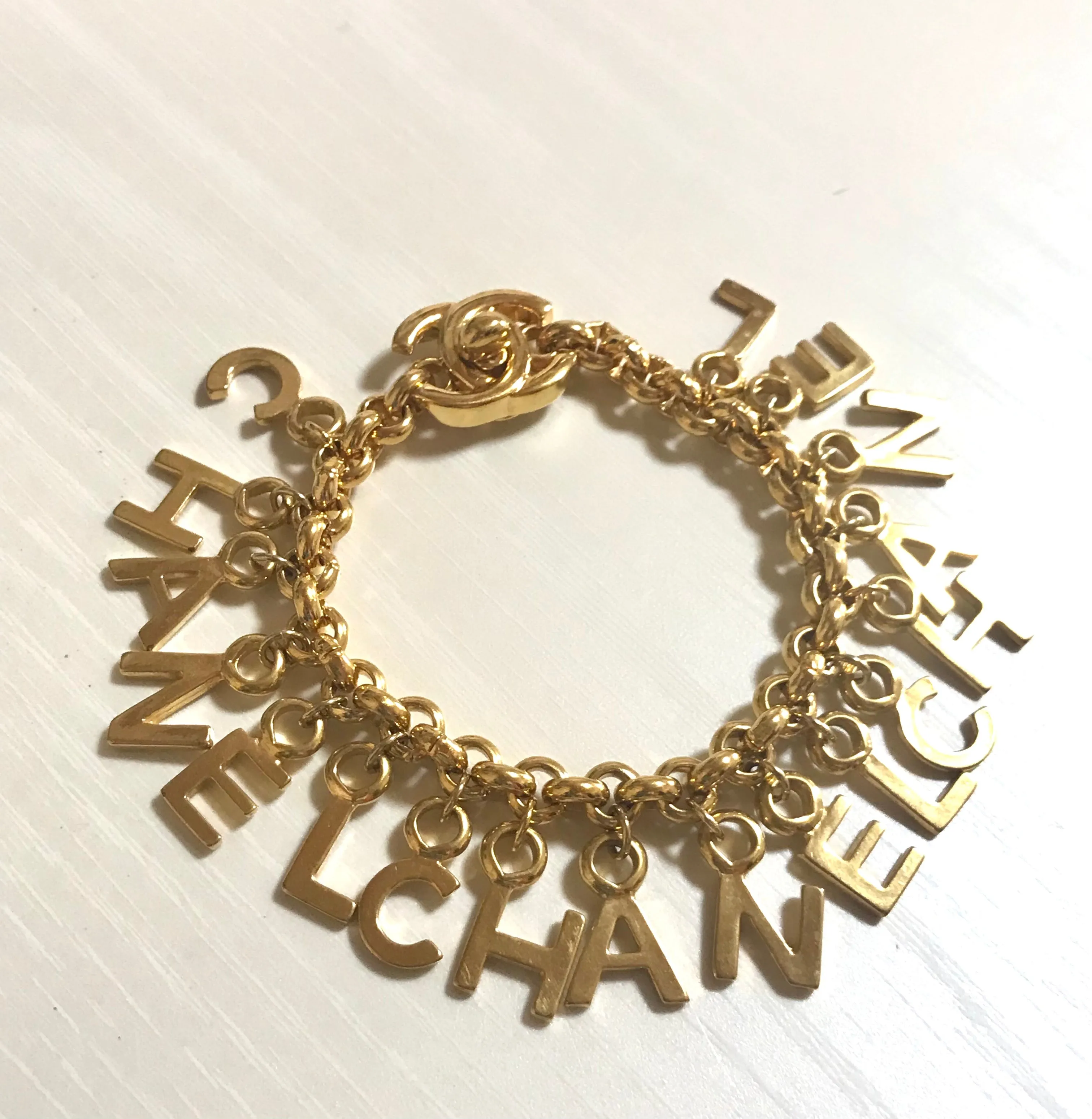 Vintage Chanel Turnlock CC closure and CHANEL letter dangle bracelet. Must have 90s jewelry. CC and logo letter charm bracelet. 060801re